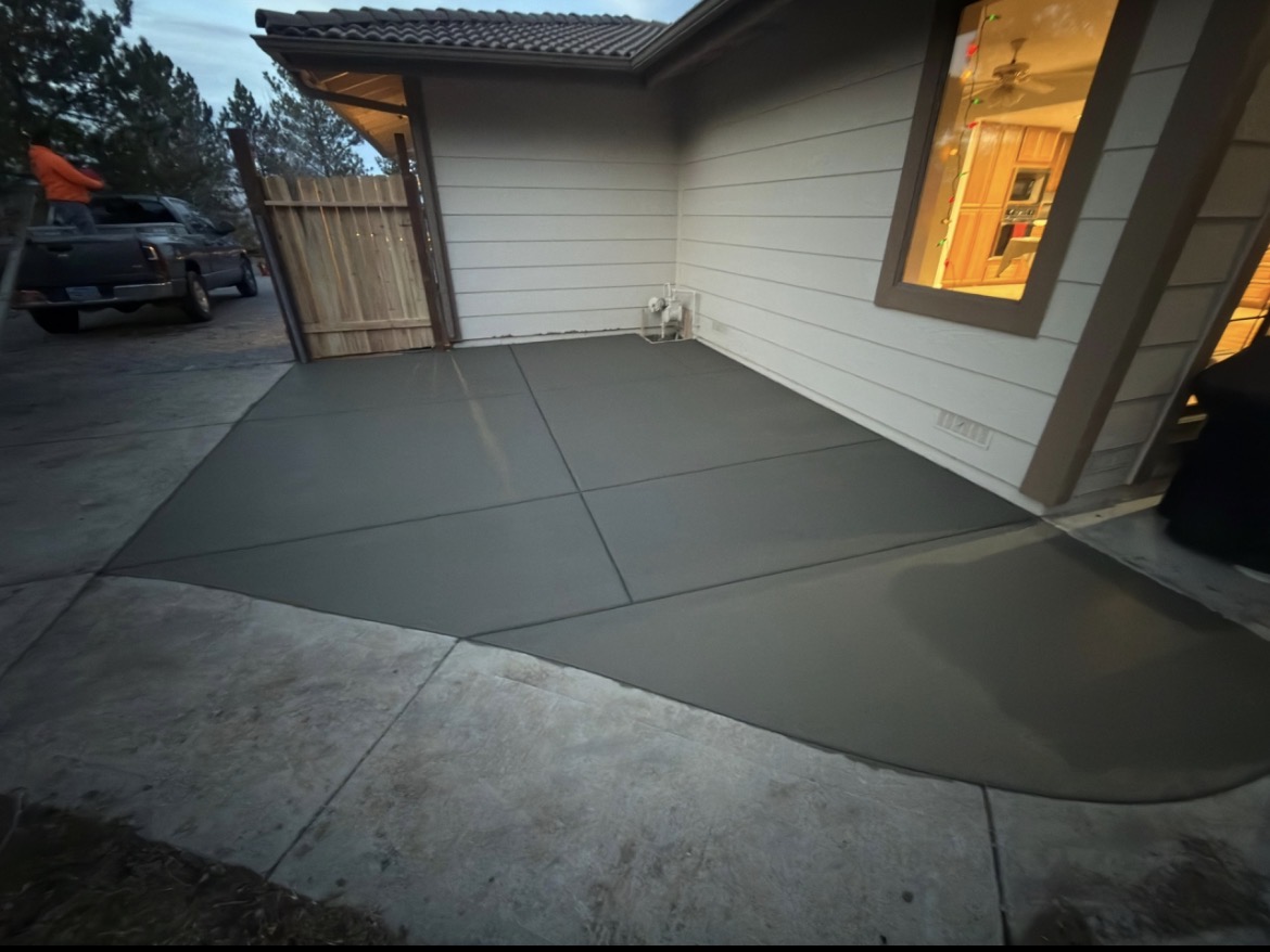 Fresh concrete patio pour alongside home